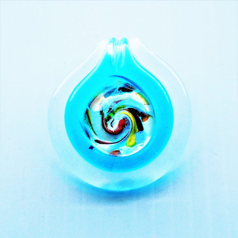 Bohemian Hippie Style glass artwork pendant. Clear in color with teal accents. Measures just over 1.5 inches across center. Never worn.
