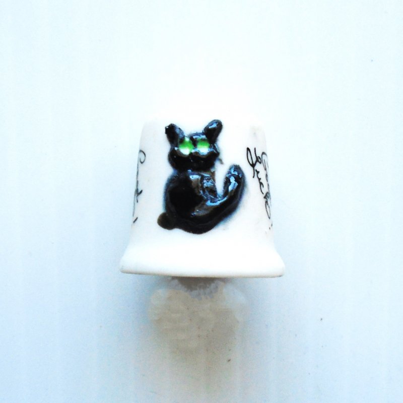 Black cat collectible porcelain thimble with the words ‘Good Luck’.