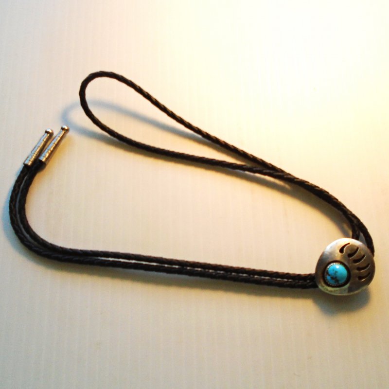 Bear’s Paw Bolo tie. 925 Sterling with turquoise stone. 36 inch leather cord. Estimated 1970s.
