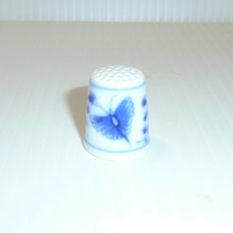 Vintage collectable thimble featuring a blue and white butterfly. Marked inside with the B&G emblem, the number 4801, and 