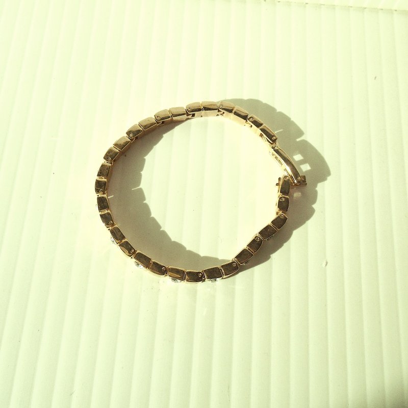 Gold tone 7.5 inch bracelet with 13 CZ stones. Possible gold fill. Estate find.