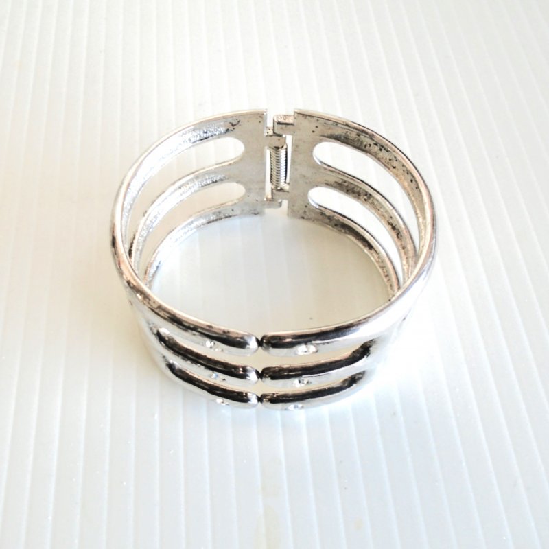 Bohemian style three band stainless steel hinged cuff bracelet with rhinestones.