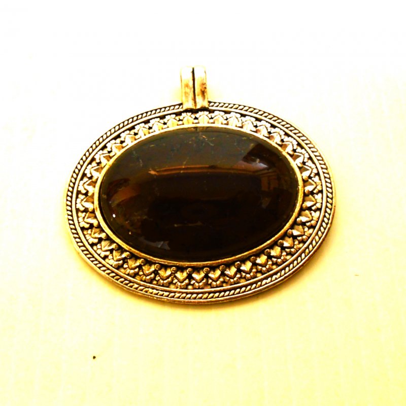 Apache Tears pendant, a beautiful jet black stone, in a silvertone metal casing.