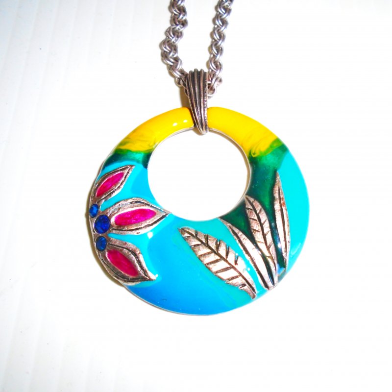 Chico’s multi color enamel disc necklace with flower theme and green rhinestones.