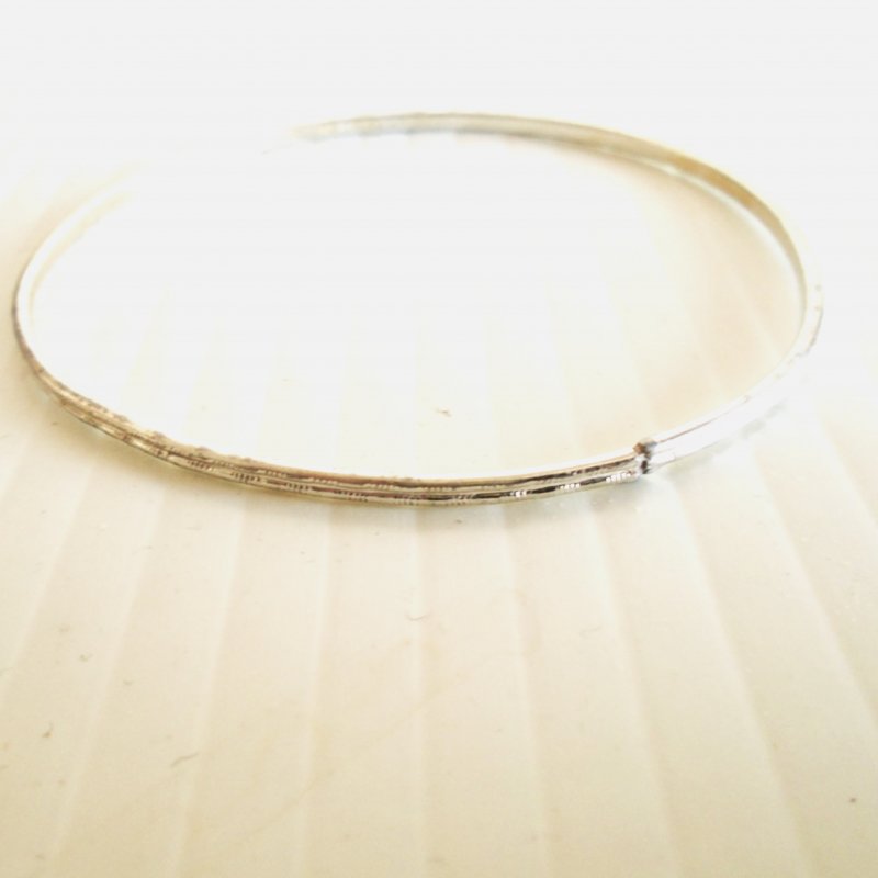Stainless Steel bangle bracelet, stated to be mid century. Marked “Germany”. 2.75 inch opening.