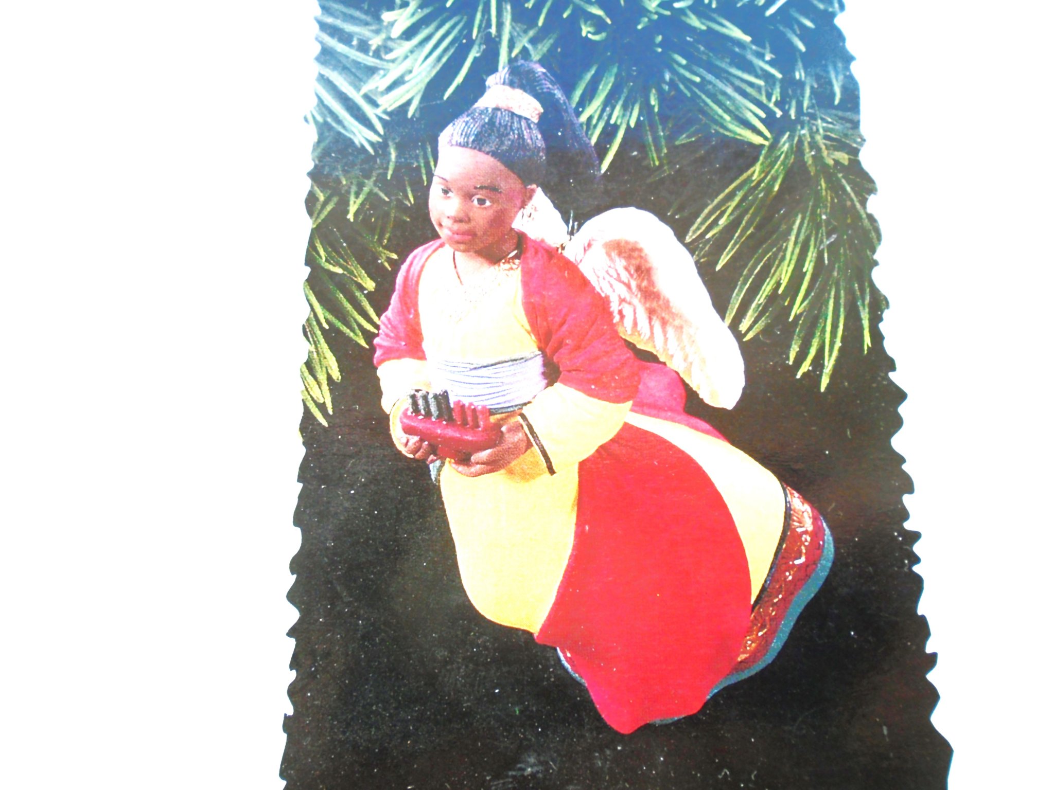 Hallmark Ornament titled ‘A Celebration of Angels’. Features an African American Angel. Dated 1996. New NOS (New Old Stock). Never used. Comes in it’s original box.