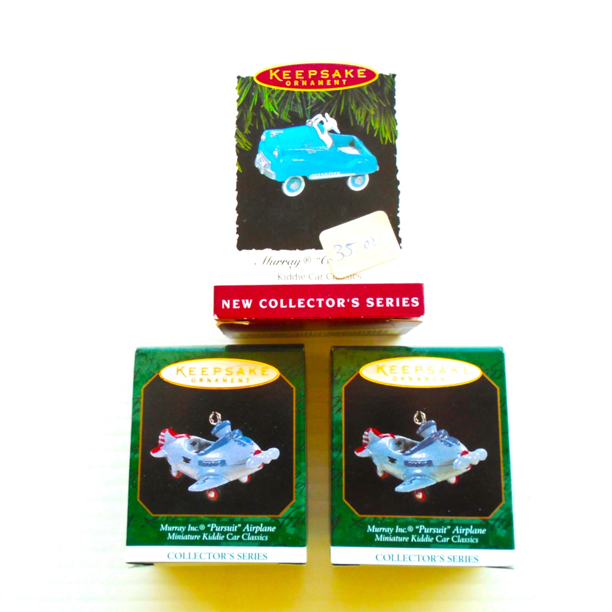 Hallmark Keepsake Ornaments. 3 Kiddie Cars. In original boxes dated in the 1990s. Never used. New Old Stock (NOS).