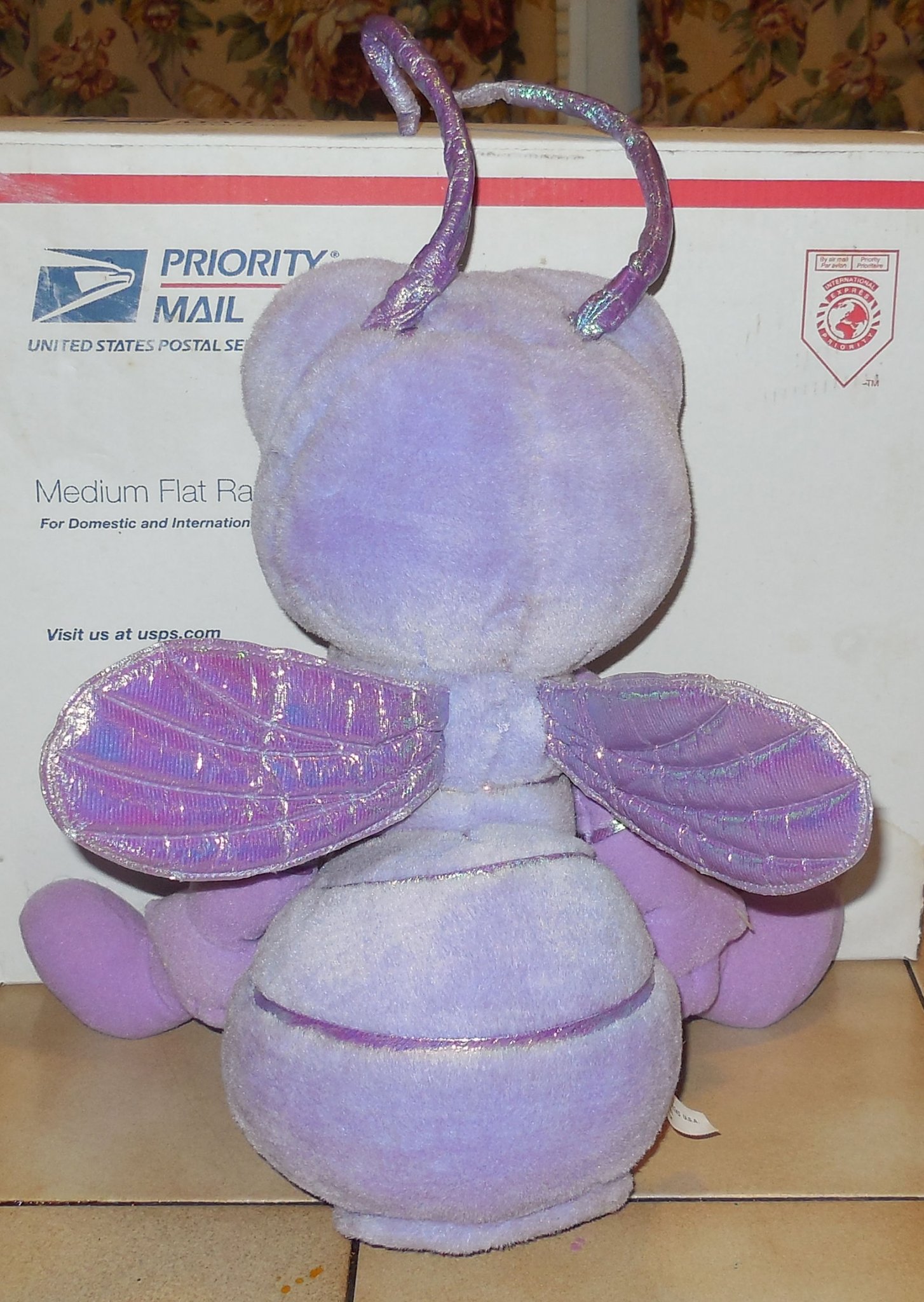 Rear view of the Mattel Princess Dot plush toy highlighting her translucent blue wings and white 1998 manufacturer tush tag.