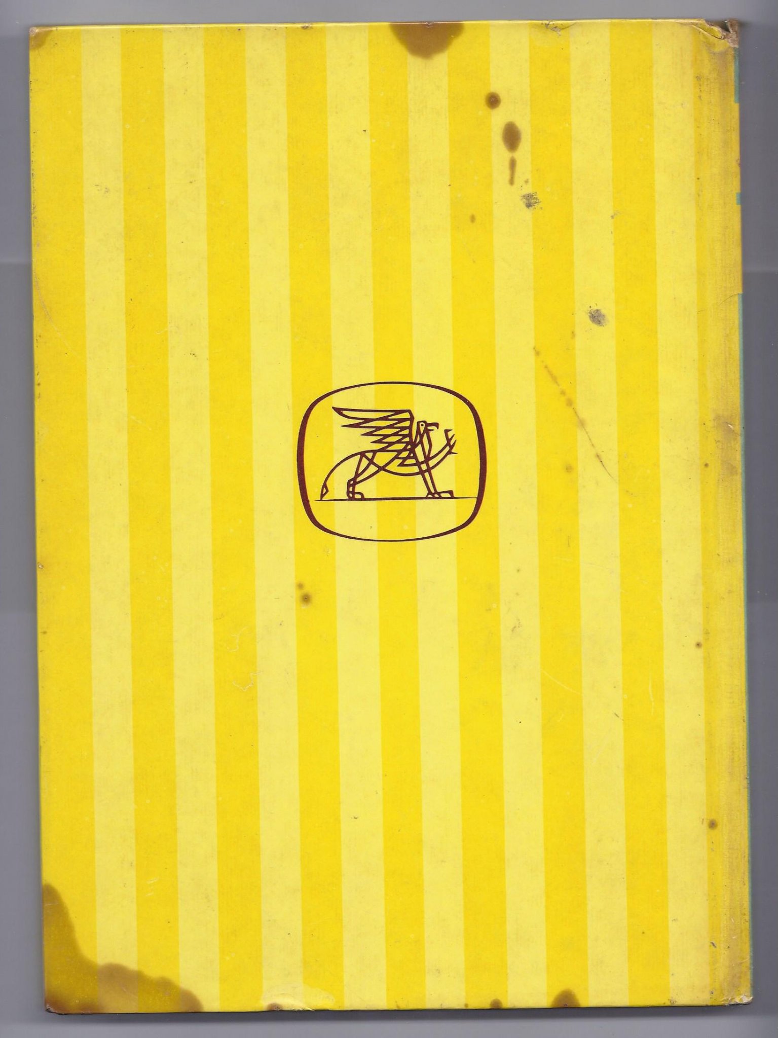 Back cover showing yellow vertical stripes, a griffin emblem, and lower-left edge staining