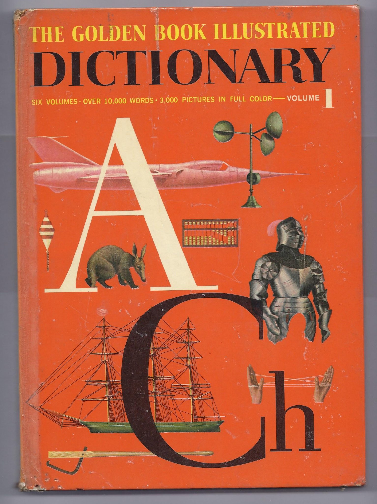 Front cover of 1961 The Golden Book Illustrated Dictionary Volume 1 featuring large letters A and Ch over an orange background with educational drawings