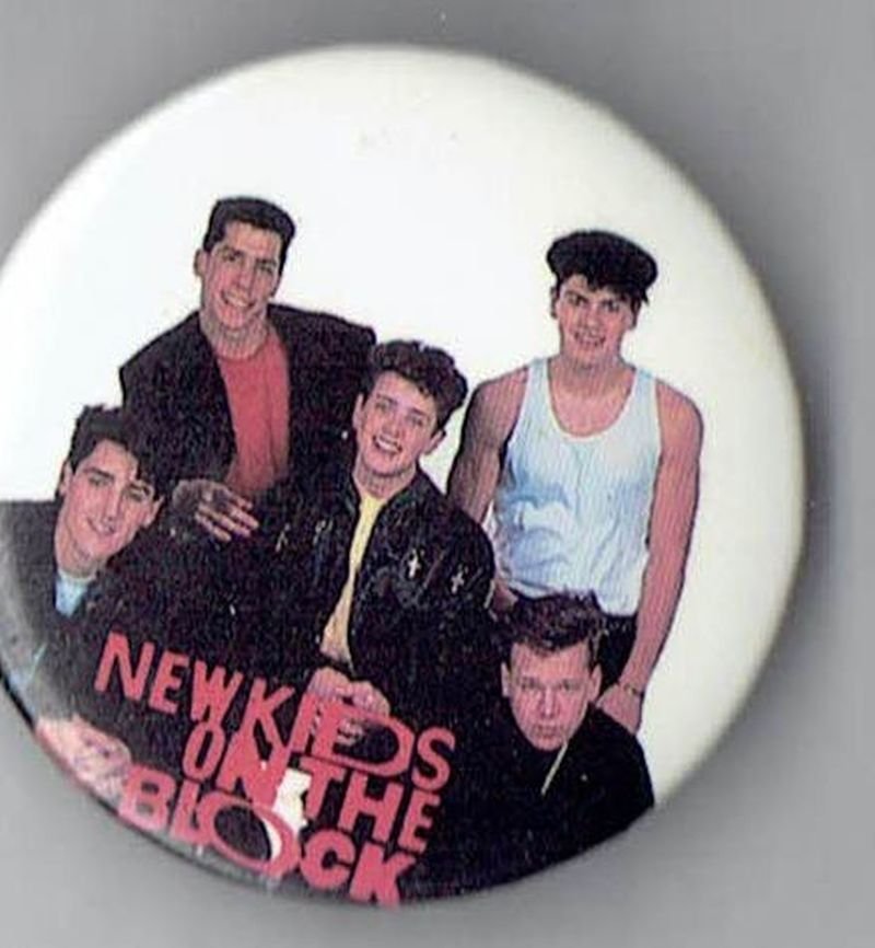 Front view of the authentic vintage New Kids on the Block 1.5 inch pinback button featuring a group photo of the band members.