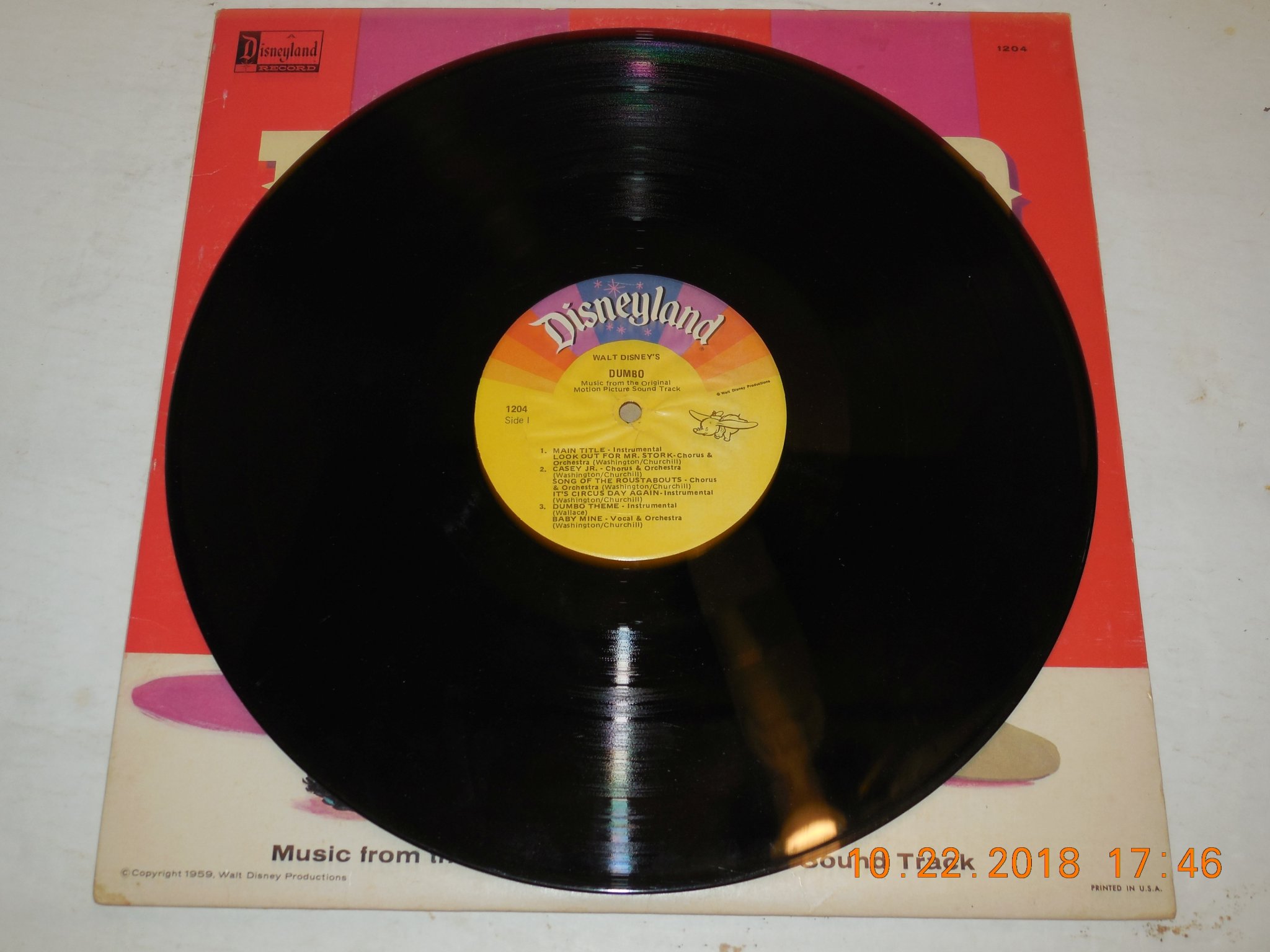 Side 1 of the black vinyl record disc showing the yellow Disneyland High Fidelity label for Walt Disney's Dumbo DQ-1204