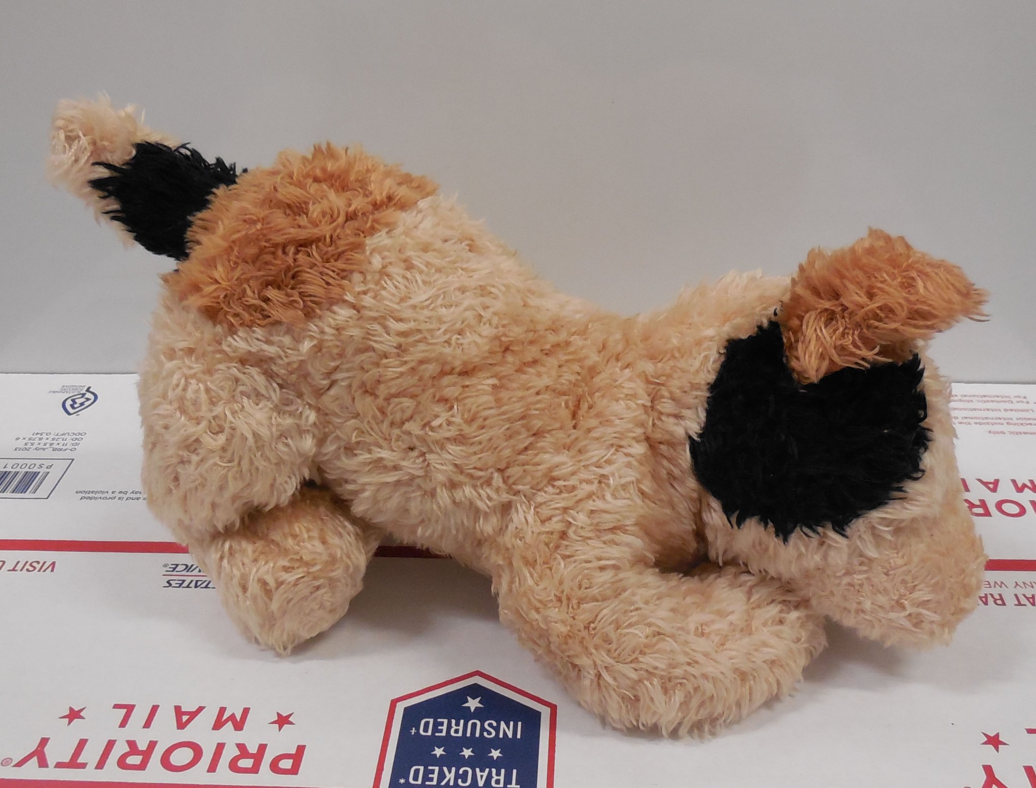 Right Side view of the authentic vintage 10 inch Gund Ketch puppy dog plush showing its beige fur and dark brown spot over its right eye.