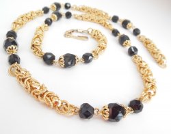 Coro Vintage Gold Black Necklace Intertwined circular Rope Chain Faceted Beads