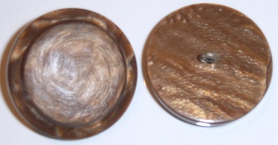 Brown button with metal loop shank.